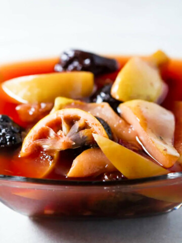 Compote in a glass bowl on a gray background.