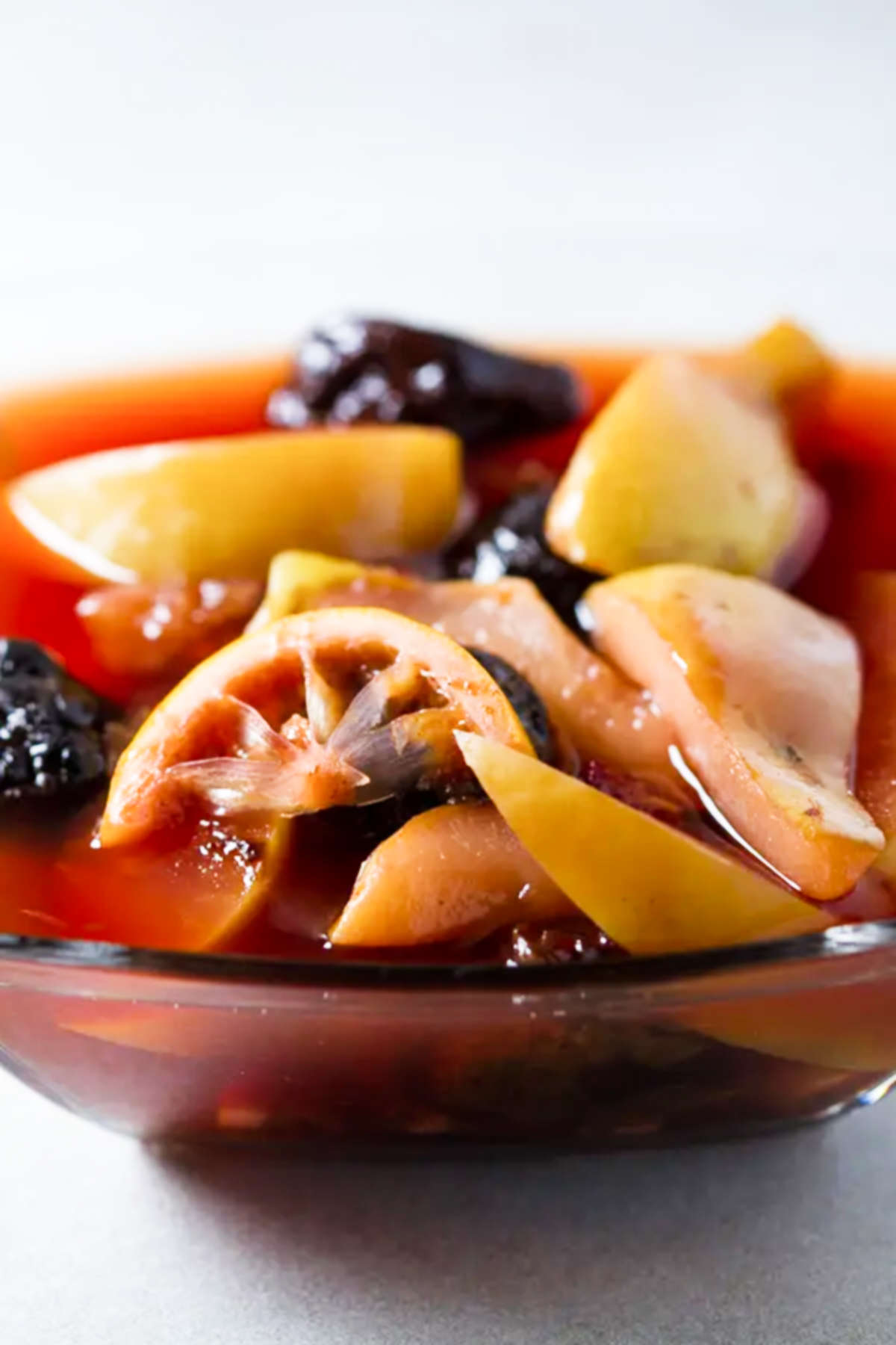 Compote in a glass bowl on a gray background.