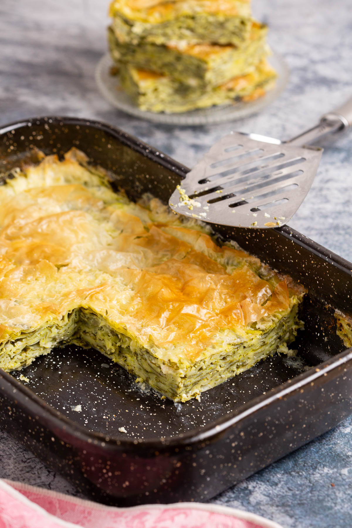 Cheese pie with spinach in a pan.