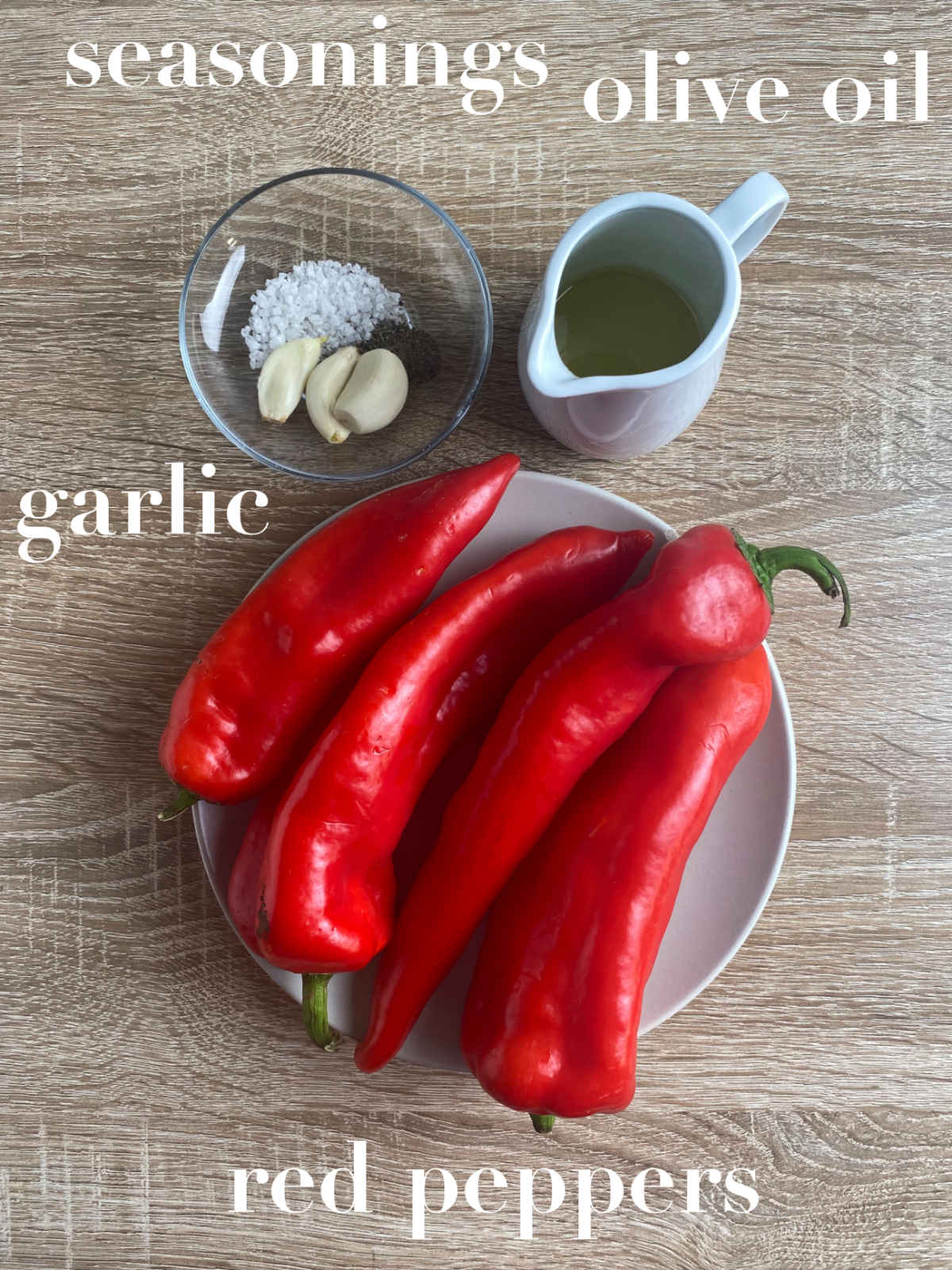 Seasonings, olive oil, garlic and red peppers on a table.