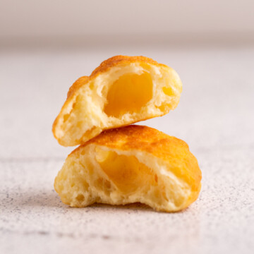 Two halves of fried dough on gray background.