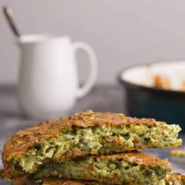 Three pieces of quiche in front of a jug and pan.