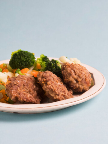 A plate filled with rissoles on a blue background.