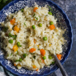 A bowl of rice overhead, with a spoon inside.