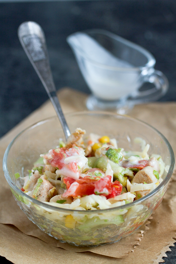 Chicken on a bed of shredded cabbage, mixed with summer favorites (corn, cucumbers and tomatoes), and topped with grated cheese and your favorite dressing. 