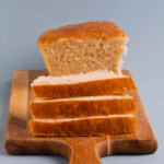Homemade bread on a cutting board on a blue background.