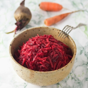 A bowl of carrot and beet salad.