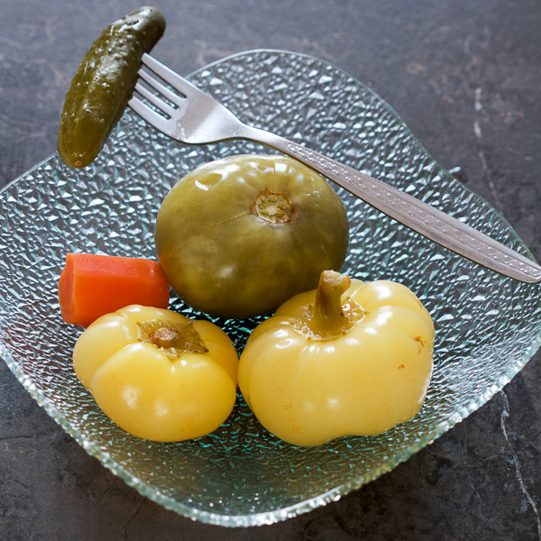 An easy guide to fermenting vegetables for salads and meals. Includes: yellow bell pepper tomatoes, green tomatoes, cabbage, carrots, cucumbers, celery root, peppercorn. 