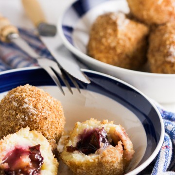 Plums encased in a potato based dumpling dough, boiled and breaded. An old Balkan delicacy.