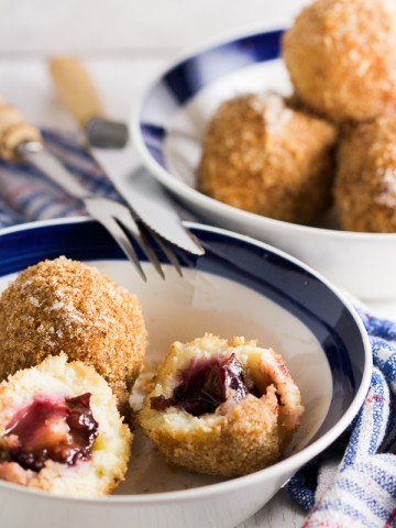 Plums encased in a potato based dumpling dough, boiled and breaded. An old Balkan delicacy.