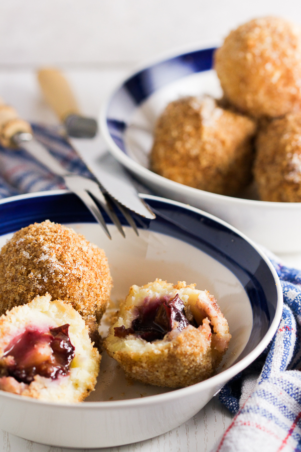 Plums encased in a potato based dumpling dough, boiled and breaded. An old Balkan delicacy. 