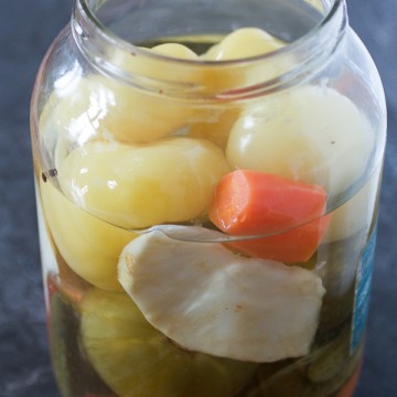 An easy guide to fermenting vegetables for salads and meals. Includes: yellow bell pepper tomatoes, green tomatoes, cabbage, carrots, cucumbers, celery root, peppercorn.