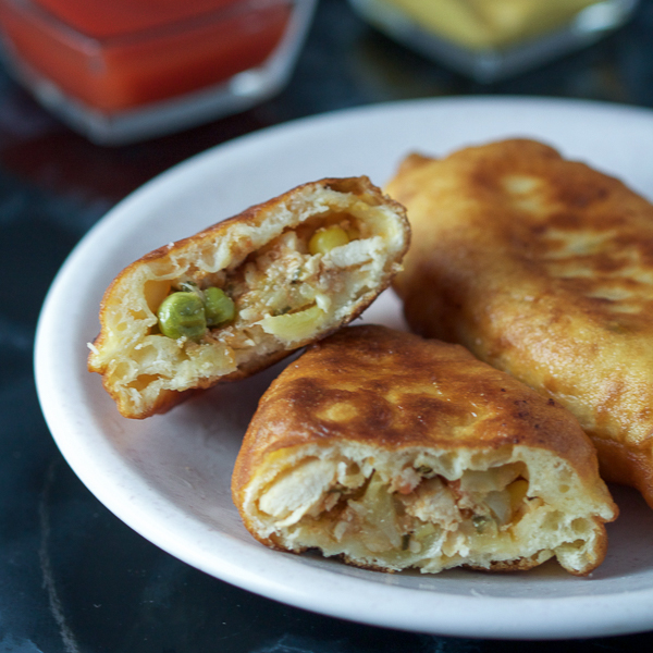 Chicken turnovers: a healthy veggie stuffing (bell peppers, corn, peas and tomatoes), combined with chicken breast, wrapped in dough, and then baked. It's like a salad, main course, and a side all in one. 