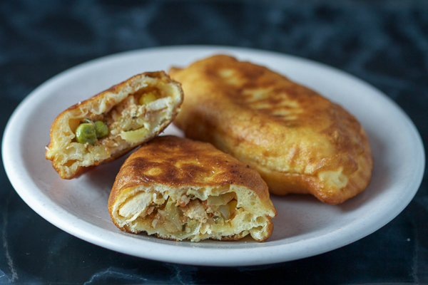 Chicken turnovers: a healthy veggie stuffing (bell peppers, corn, peas and tomatoes), combined with chicken breast, wrapped in dough, and then baked. It's like a salad, main course, and a side all in one. 