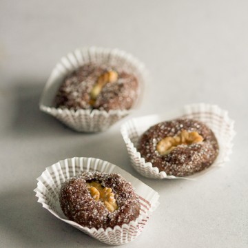 Apricot raisin walnut cookie boats: a simple cookie with a complicated name. Apricots and raisins ground in a meat grinder, combined with sugar and chocolate, then topped off with a walnut.