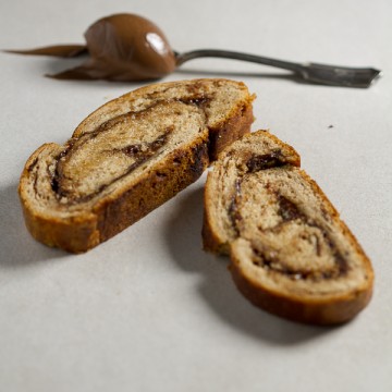 Chocolate Nutella strudel: chocolate infused flour caressed into dough, let to rise, smeared with huge chunks of Nutella, toped with egg yolk glaze, then baked. Tastes like heaven!