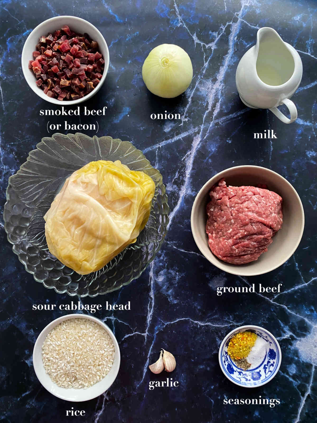 Ingredients for stuffed cabbage placed on a dark blue background. 