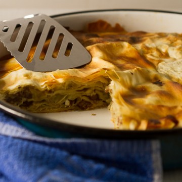 Ground beef phyllo pie. Ground beef (or veal) layered in phyllo sheets softened with butter, then baked until golden. Much pie. Not much fuss. 