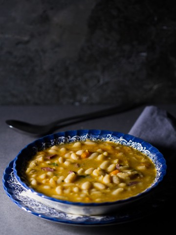 Dry beans soaked, added to simmered vegetables and meat, cooked over low fire, then thickened with a paprika based roux. The result is a delicious thick soup (stew) overflowing with meaty, hearty beans processed to perfection.