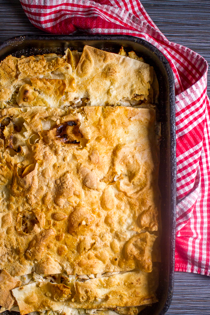 The most tender and soft chicken pie infused with homemade chicken broth. First the chicken is brought to boil until it gives its all to the broth, and then shredded. Shredded pieces are used in between crunchy phyllo (or tortillas even), which are furthermore softened with the chicken broth. You'll love this one, I promise!