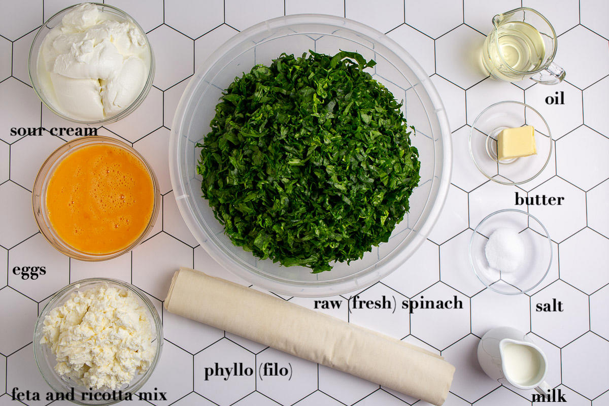 Nine spinach pie ingredients on top of the table.