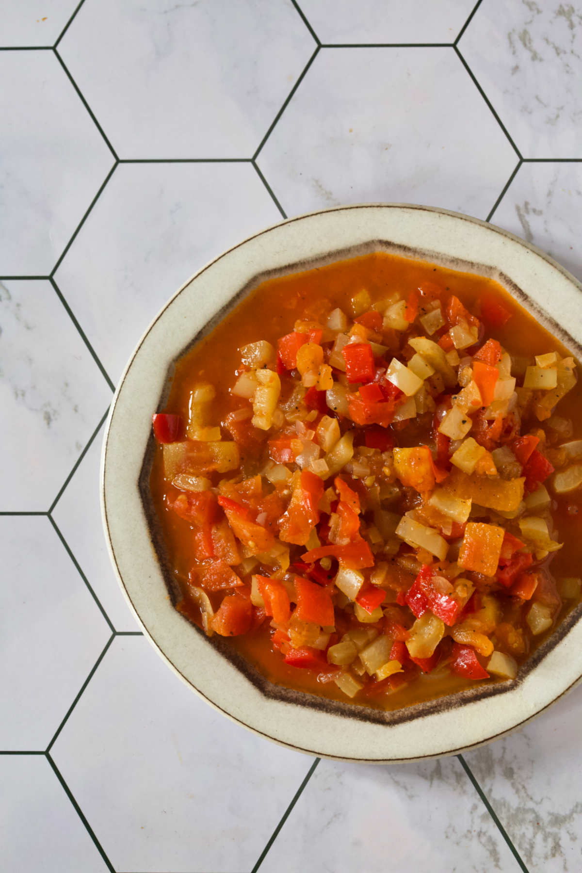 Pepper dish on a white plate on a honeycomb background.