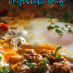 A pin depicting poached eggs on a bed of ground beef.