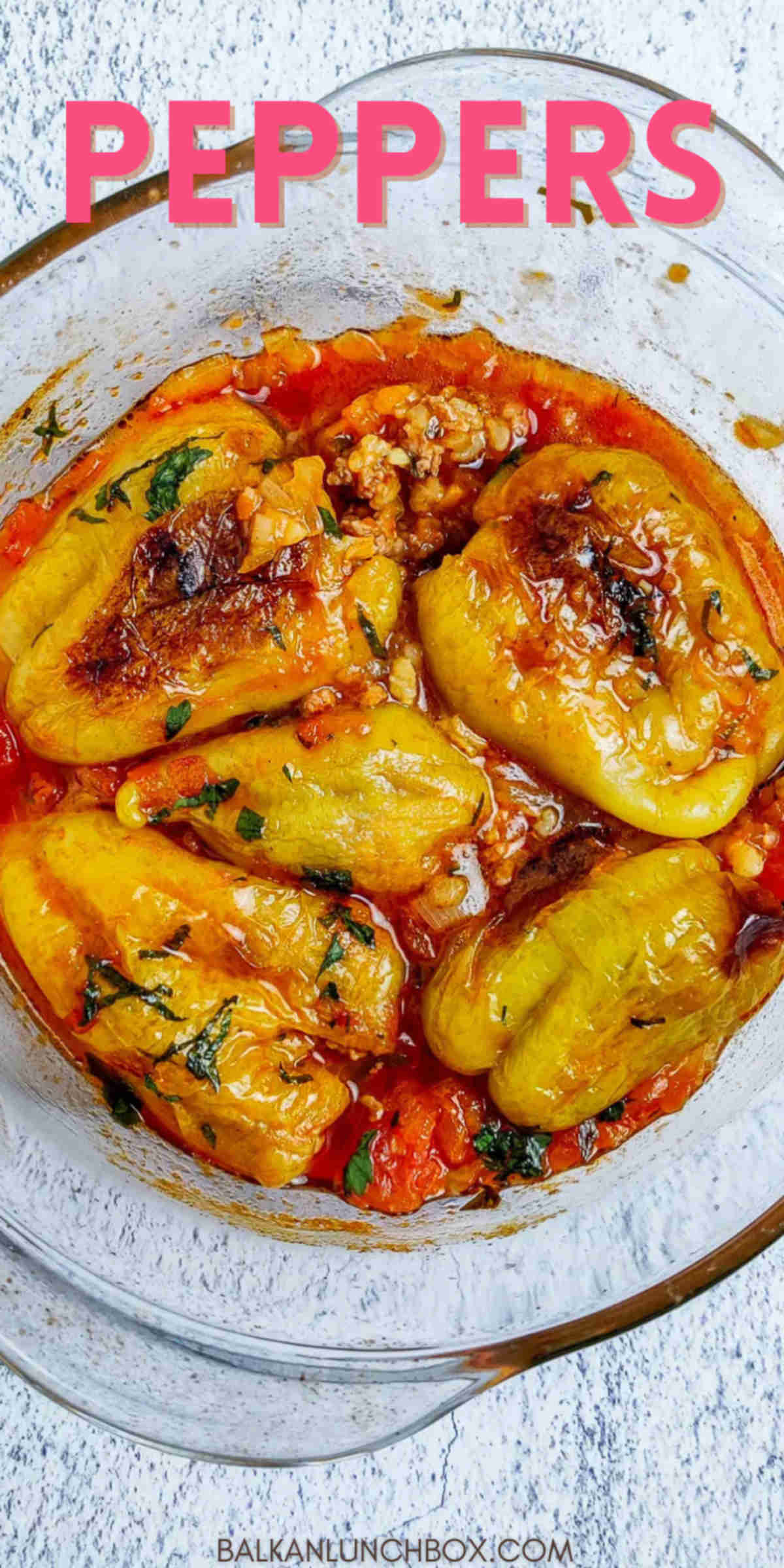 A glass bowl full of stuffed peppers. 