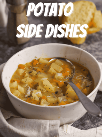 A bowl of potato soup on a marble table with bread.
